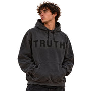 A man wearing a dark gray washed hoodie with the word 'TRUTH' printed in black across the chest, shown against a plain white background.